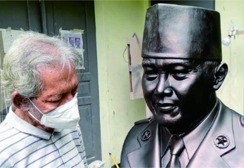 Azmir Azhari dengan patung wajah Bung Karno di era 1961-1964 yang tidak begitu familiar bagi publik Indonesia. Foto: Instagram @azmir_azhari Azmir Azhari dengan patung wajah Bung Karno di era 1961-1964 yang tidak begitu familiar bagi publik Indonesia. Foto: Instagram @azmir_azhari